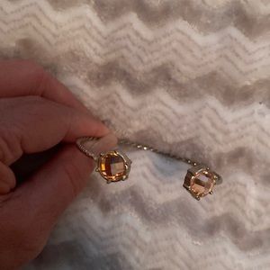 Goldtoned open bangle with pink crystals on edges